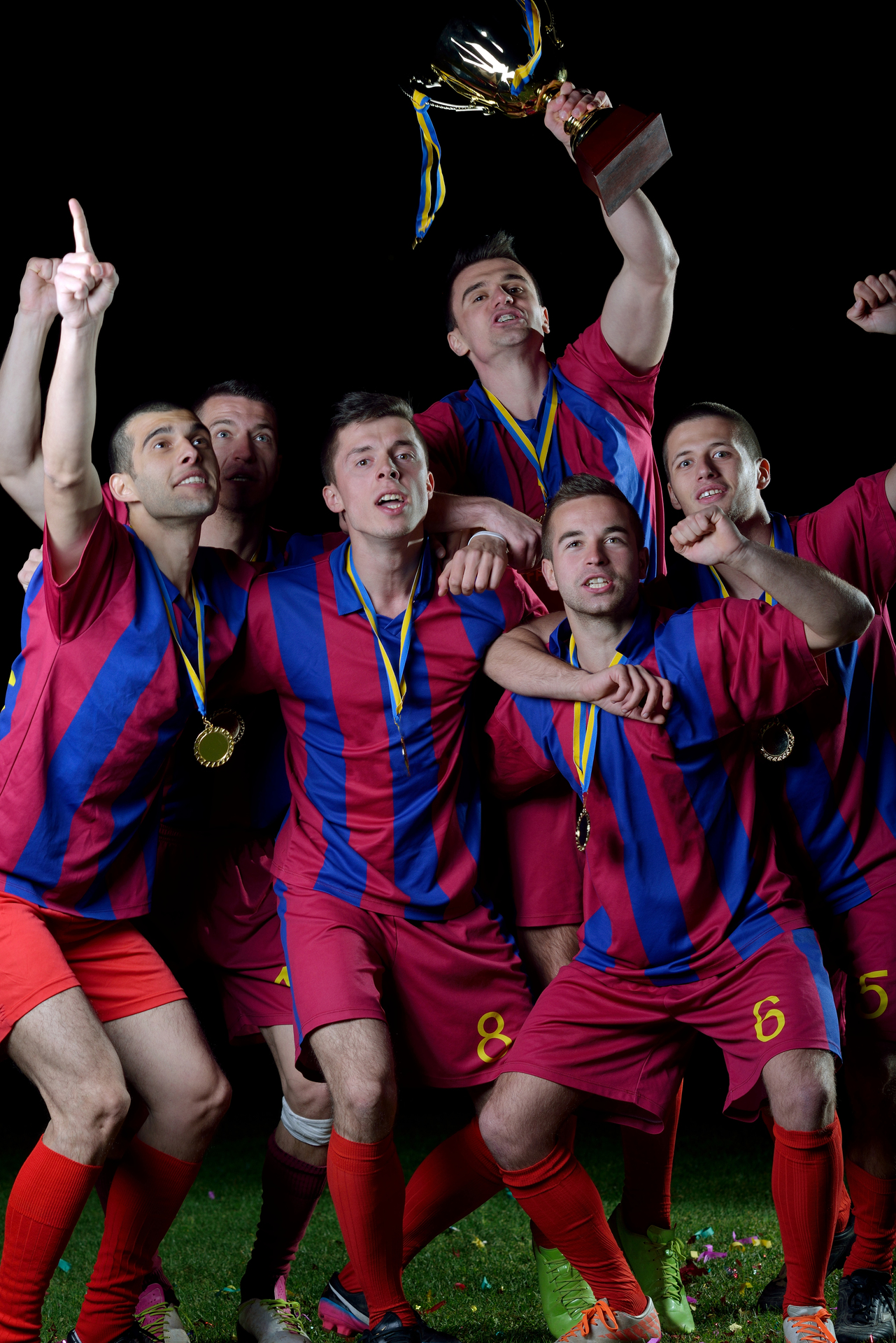 soccer players team group celebrating the victory and become champion of game while holding win coup